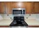Well-lit kitchen features stainless steel microwave and black stovetop at 6304 Timberline Dr. # B, Myrtle Beach, SC 29572