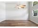 Living room with wood floors, a ceiling fan, and a large window at 6304 Timberline Dr. # B, Myrtle Beach, SC 29572
