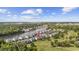 Aerial view of community with a boat on the waterway with golf course and red arrow marking the home at 633 Waterway Village Blvd # 11D, Myrtle Beach, SC 29579