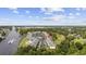 Aerial view of the community with a boat on the waterway with golf course and red arrow marking the home at 633 Waterway Village Blvd # 11D, Myrtle Beach, SC 29579