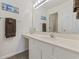 Bright bathroom with a single sink vanity, large mirror, and beach themed artwork at 633 Waterway Village Blvd # 11D, Myrtle Beach, SC 29579