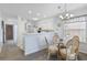 Cozy dining area with a glass table, wicker chairs, and a view of the kitchen at 633 Waterway Village Blvd # 11D, Myrtle Beach, SC 29579