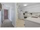 Bright kitchen featuring white cabinets, modern appliances, and a door leading outside at 633 Waterway Village Blvd # 11D, Myrtle Beach, SC 29579