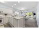 Open-concept kitchen with white cabinets, modern appliances, and a view into the living room at 633 Waterway Village Blvd # 11D, Myrtle Beach, SC 29579
