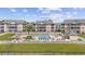 Outdoor pool with a white picket fence and tables, chairs, and lounge chairs around the deck at 633 Waterway Village Blvd # 11D, Myrtle Beach, SC 29579