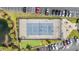 Aerial view of community tennis court with parking and a green space in the background at 633 Waterway Village Blvd # 11D, Myrtle Beach, SC 29579