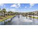 Scenic water feature with a bridge, palm trees, condos and parking in the distance at 633 Waterway Village Blvd # 11D, Myrtle Beach, SC 29579