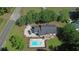Aerial view of home with swimming pool, deck, and a large lot surrounded by mature trees at 669 George Washington Trail, Georgetown, SC 29440