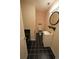 Cozy bathroom with black and white tile flooring, sink with vanity, and toilet at 669 George Washington Trail, Georgetown, SC 29440