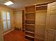 Walk-in closet with built-in shelving and wooden floors at 669 George Washington Trail, Georgetown, SC 29440