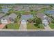 Residential home featuring a manicured lawn and tropical landscaping nestled in a lakeside community at 691 Sandberg St., Surfside Beach, SC 29575
