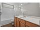 Bright bathroom with a shower over the tub, white fixtures, and wood vanity at 691 Sandberg St., Surfside Beach, SC 29575