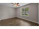 Bedroom with a ceiling fan and large window overlooking the front yard at 691 Sandberg St., Surfside Beach, SC 29575