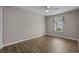 Bedroom with wood-look flooring and a large window with blue curtains at 691 Sandberg St., Surfside Beach, SC 29575