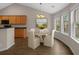 Cozy breakfast nook featuring a round table, wood cabinets, and bright windows at 691 Sandberg St., Surfside Beach, SC 29575