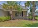This home features a charming front porch with brick accents and lush landscaping at 691 Sandberg St., Surfside Beach, SC 29575
