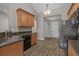 Functional kitchen with granite countertops, stainless steel refrigerator, and wood cabinetry at 691 Sandberg St., Surfside Beach, SC 29575