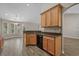 Open-concept kitchen features wood cabinets, granite counters, and seamlessly connects to the dining area at 691 Sandberg St., Surfside Beach, SC 29575