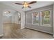 Open-concept living area boasts wood floors, arched doorways, and sunlit windows at 691 Sandberg St., Surfside Beach, SC 29575