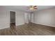 Spacious main bedroom with wood flooring, ceiling fan, and walk in closet at 691 Sandberg St., Surfside Beach, SC 29575