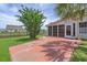 Outdoor patio featuring a mature tree for shade and a view of the fenced backyard and neighboring property at 691 Sandberg St., Surfside Beach, SC 29575