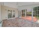 Enclosed sunroom with tile floor, ceiling fan, and sliding doors at 691 Sandberg St., Surfside Beach, SC 29575