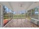 Bright sunroom with large windows, tile flooring, and ceiling fan at 691 Sandberg St., Surfside Beach, SC 29575