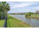 Scenic waterfront view from the backyard, showcasing the serene pond, fountain, and neighboring homes at 691 Sandberg St., Surfside Beach, SC 29575
