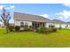 Backyard with a grassy lawn, patio and garden beds and white fence in view at 696 Rambler Ct., Myrtle Beach, SC 29588