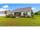 Wide backyard with a grassy lawn, patio and garden beds in view at 696 Rambler Ct., Myrtle Beach, SC 29588