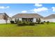 Wide backyard with a grassy lawn, patio and garden beds in view at 696 Rambler Ct., Myrtle Beach, SC 29588