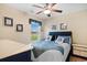 Nautical-themed bedroom with a full-sized bed, blue bedding, ceiling fan, and decorative wall art at 696 Rambler Ct., Myrtle Beach, SC 29588
