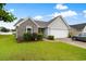 Charming one-story home with brick and siding, green lawn, and attached two car garage at 696 Rambler Ct., Myrtle Beach, SC 29588