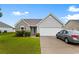 Charming single-story home with a gray brick and siding exterior, a two-car garage, and a landscaped yard at 696 Rambler Ct., Myrtle Beach, SC 29588