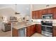Open-concept kitchen featuring stainless steel appliances and a convenient breakfast bar overlooking the living room at 696 Rambler Ct., Myrtle Beach, SC 29588
