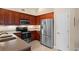 Well-equipped kitchen featuring stainless steel appliances, granite countertops, and cherry wood cabinetry at 696 Rambler Ct., Myrtle Beach, SC 29588