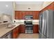 Well-equipped kitchen featuring stainless steel appliances, ample counter space, and cherry wood cabinetry at 696 Rambler Ct., Myrtle Beach, SC 29588