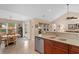 Bright kitchen boasts stainless steel appliances, a breakfast bar, and a seamless transition to the dining area at 696 Rambler Ct., Myrtle Beach, SC 29588