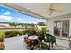 Relaxing covered patio with a ceiling fan, outdoor furniture, and a serene pond view at 696 Rambler Ct., Myrtle Beach, SC 29588