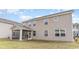 Rear exterior view of a modern two-story home, featuring a screened-in porch and a well-maintained yard at 740 Choctaw Dr., Conway, SC 29526