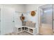 Inviting entryway featuring a built-in bench with storage, coat hooks, and a view into the adjacent bathroom at 756 Choctaw Dr., Conway, SC 29526
