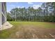 Spacious backyard with lush greenery and a treeline at 760 Charter Dr. # D-4, Longs, SC 29568