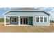View of the rear of the house with a covered patio and sliding glass doors to the backyard at 764 Choctaw Dr., Conway, SC 29526