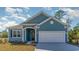 Charming one-story home with blue siding, a two-car garage, and well-manicured lawn at 764 Choctaw Dr., Conway, SC 29526