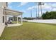 Spacious backyard with green grass, a covered patio, and a white privacy fence for outdoor enjoyment at 787 Dusty Pine Way, Myrtle Beach, SC 29588