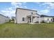Large grassy backyard featuring a covered patio, ideal for outdoor entertaining at 787 Dusty Pine Way, Myrtle Beach, SC 29588