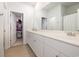 Bright bathroom with a long vanity, white cabinets, and a large mirror at 787 Dusty Pine Way, Myrtle Beach, SC 29588