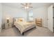 Bright bedroom with a ceiling fan, window, and a comfortable bed with a striped coverlet at 787 Dusty Pine Way, Myrtle Beach, SC 29588