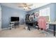 Bedroom featuring an organized gaming setup with a comfortable desk, chair, and soft blue walls at 787 Dusty Pine Way, Myrtle Beach, SC 29588