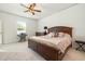 Cozy bedroom with a large bed, ceiling fan, and natural light from the window at 787 Dusty Pine Way, Myrtle Beach, SC 29588